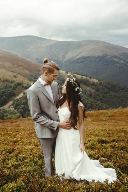 istock gorgeous bride and stylish groom posing hugging,  boho wedding couple, luxury ceremony at mountains with amazing view 1134192058