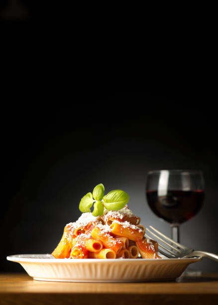 dish with macaroni and toamato sauce on the wooden table
