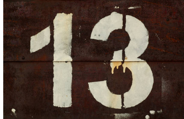 istock Number 13 in stencil on metal wall. 1134192212
