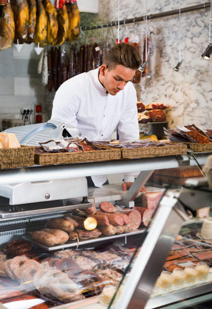 istock Shop-boy in special clothing shifting sausage 1134192598
