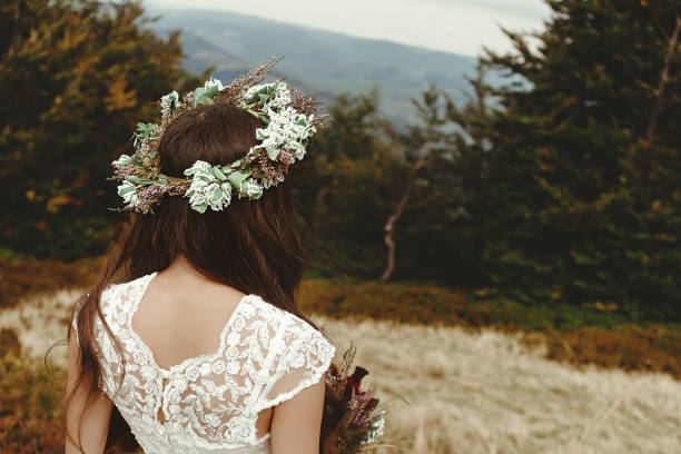 istock stylish bride posing with bouquet on background of forest, luxury boho wedding at mountains 1134192617