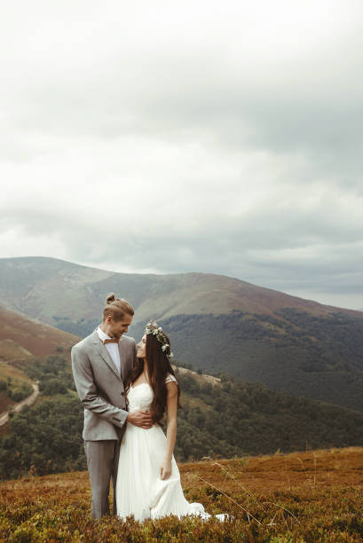 istock gorgeous bride and stylish groom posing hugging,  boho wedding couple, luxury ceremony at mountains with amazing view 1134192646