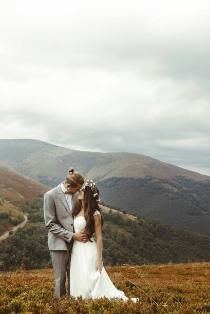 istock gorgeous bride and stylish groom posing hugging,  boho wedding couple, luxury ceremony at mountains with amazing view 1134192761