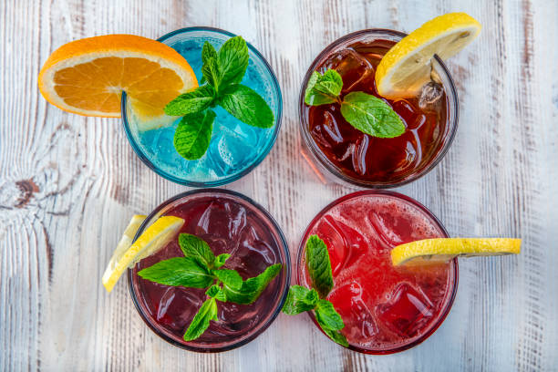 On a wooden table; Blue Hawaiian, Ice Tea, Strawberry Mojito and Forest Fruity Iced Drink. On a wooden table; Blue Hawaiian, Ice Tea, Strawberry Mojito and Forest Fruity Iced Drink. non alcoholic beverage photos stock pictures, royalty-free photos & images