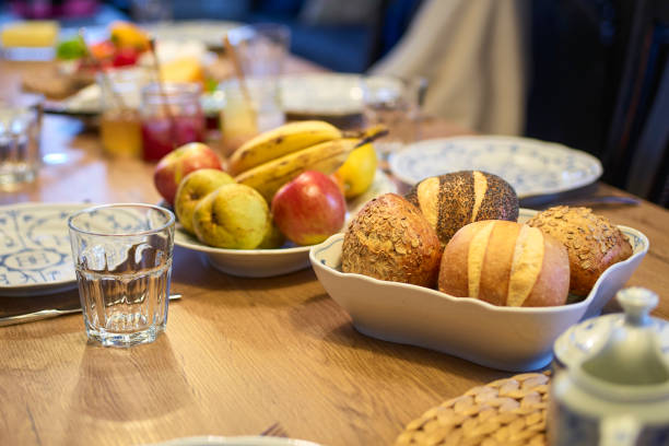 istock wooden table set for breakfast focused on rolls 1134197136
