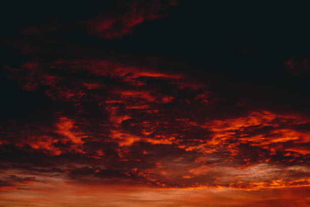 istock Fiery red blood vampire dawn. Amazing warm dramatic fire cloudy sky. Vivid orange sunlight. Atmospheric background of sunrise in overcast weather. Hard cloudiness. Storm clouds warning. Copy space. 1134198332
