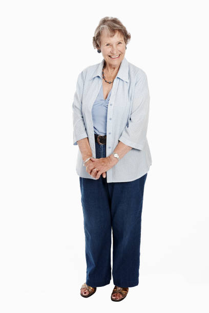 istock Cheerful senior woman standing on white, smiling 1134200921