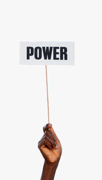 Single raised hand holds sign reading "Power" A single hand holds a sign aloft reading "Power" against a white background. autocratic leadership stock pictures, royalty-free photos & images