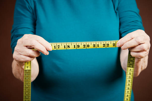 istock Senior hands holding out tape, measuring something 1134202863