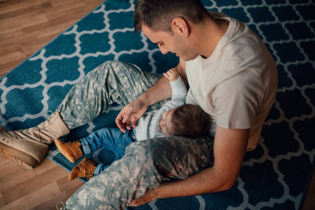 istock Soldier dad bottle feeding his little boy 1134205796