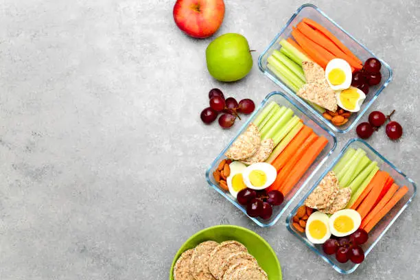 Photo of Lunch boxes with healthy snacks, overhead view