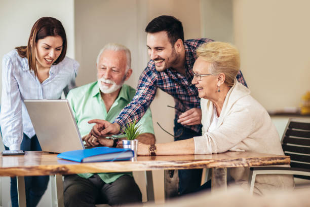 istock Young volunteers help senior people on the computer 1134214373