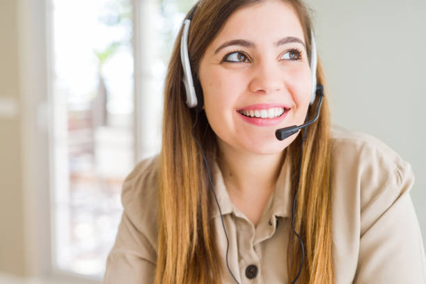 istock Beautiful young operator woman wearing headset at the office smiling looking side and staring away thinking. 1134221426