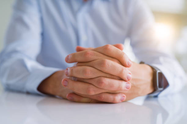 istock Close up of man crossed hands over white table 1134226884