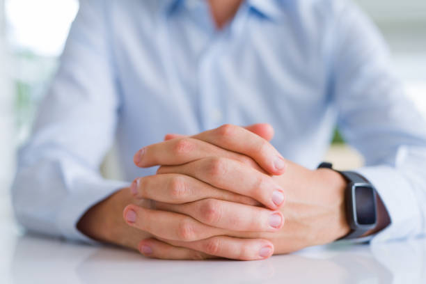 istock Close up of man crossed hands over white table 1134227275