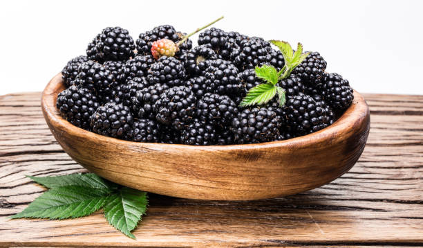 istock Blackberries in the wooden bowl on the table. 1134227619