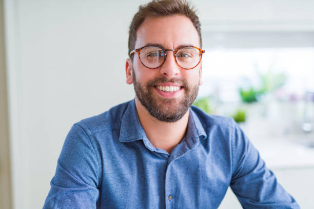 istock Handsome man wearing glasses and smiling relaxed at camera 1134227880