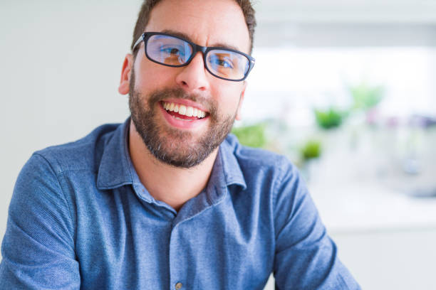 istock Handsome man wearing glasses and smiling relaxed at camera 1134227902