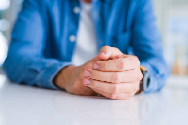 istock Close up of man crossed hands over white table 1134228804