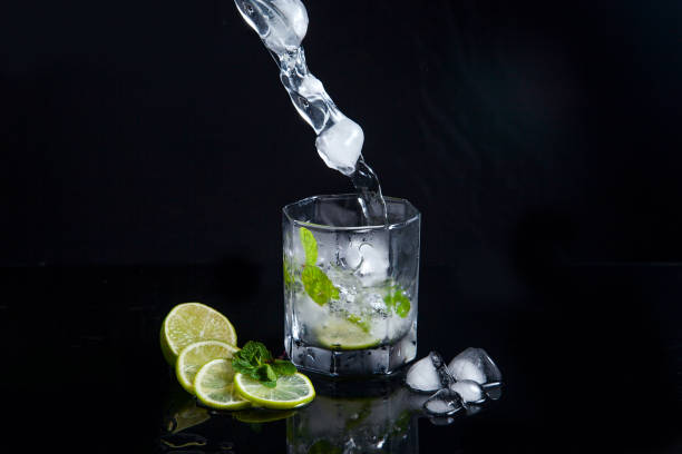 istock Summer cocktail mojito with splash on black background. 1134231077