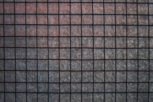 istock Metal net square with gray concrete wall texture background. 1134231489