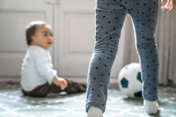 istock Kids playing with soccer ball at home 1134233125