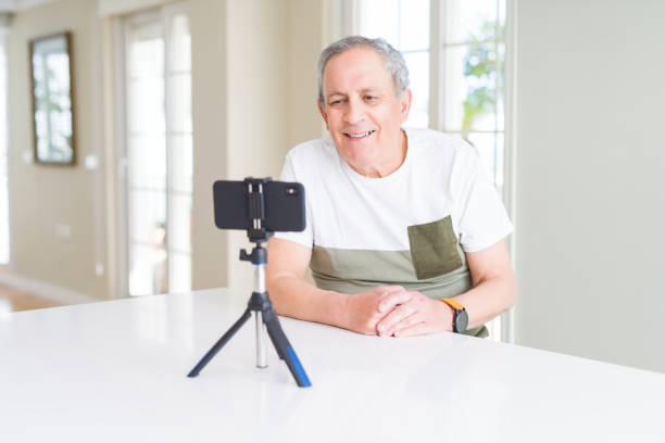istock Handsome senior man smiling very happy to the smartphone camera doing video 1134236653