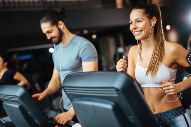 istock Young man adjusting speed on a treadmill at gym 1134238973