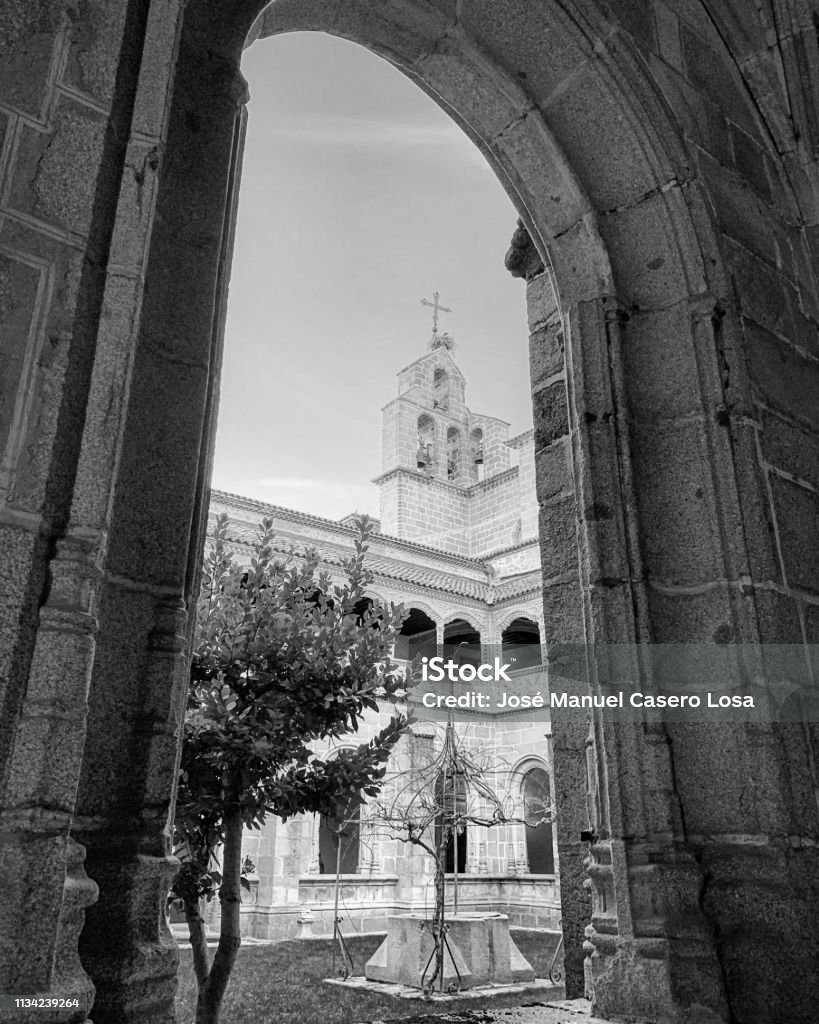 Church tower through arch at Ávila, Spain. Ancient Stock Photo