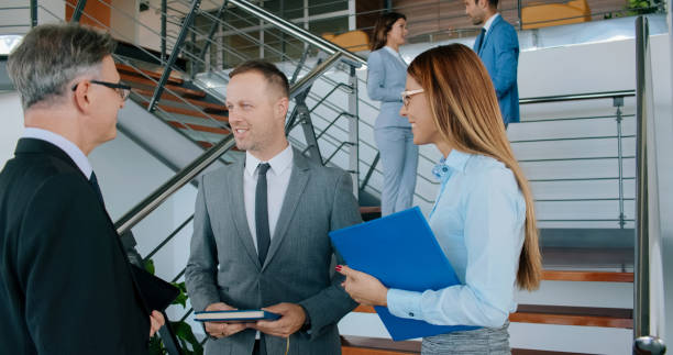 istock Smiling business people chatting in the lobby 1134239330