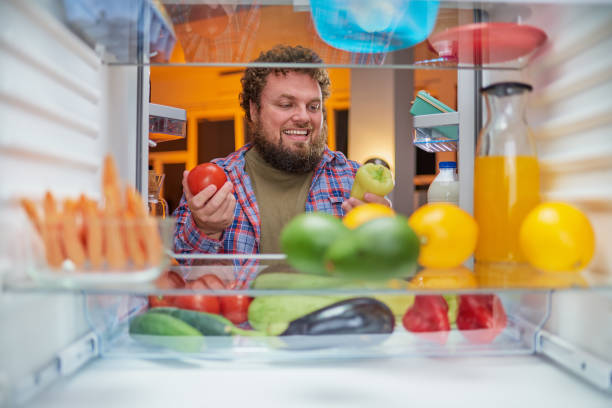 istock Man choosing what to eat late at night. 1134239449