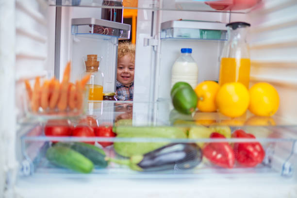 istock Toddler stealing food from fridge. 1134240126