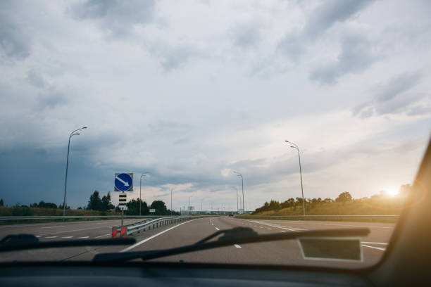 istock Grey clouds and sky from the driver's view. Windscreen wipers. Travel lifestyle concept. 1134240140