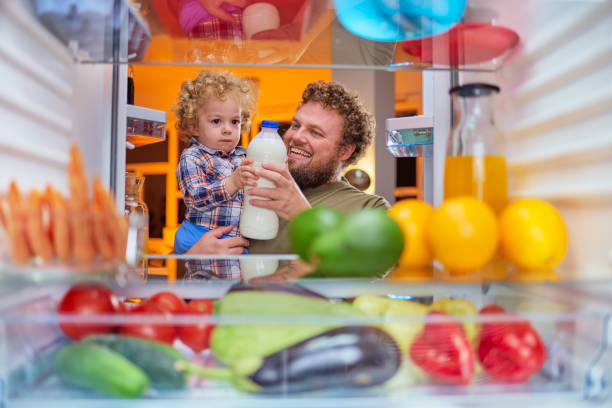 istock Father and son taking milk from fridge in late hours. 1134240177