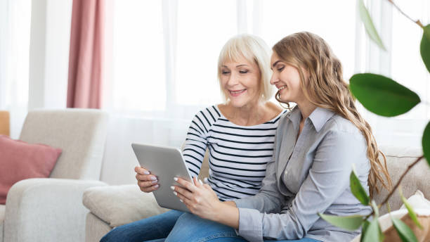 istock Senior mother and daughter using tablet, watching video 1134242057