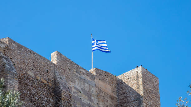 istock Athens, Greece, Greek flag on Acropolis rock waving on blue sky 1134242611