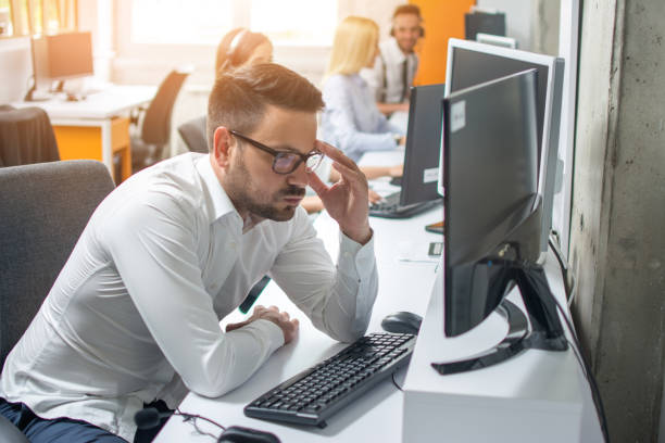 istock Worried businessman looking at computer screen at his workplace in office 1134245630
