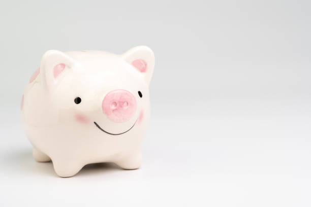 Smile pink piggy bank on white background with copy space using as happy saving and investment or positive economic and finance concept.