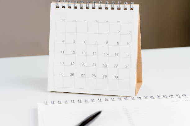 istock White clean desktop calendar on desk with pen and note pad using as reminder or planning 1134246146