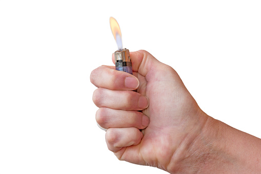 hand holding burning lighter - isolated on white background