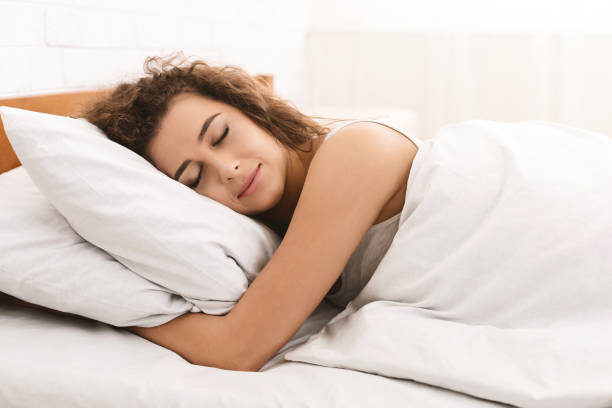 istock Young woman sleeping in bed in morning 1134246610