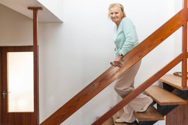 istock Elderly woman at home using a cane to get down the stairs 1134247453