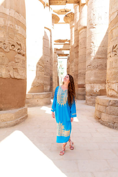 Traveler At Heart Beautiful caucasian woman enjoying a tour at the Great Temple of Amun in Karnak, Egypt. temple of luxor hypostyle hall stock pictures, royalty-free photos & images