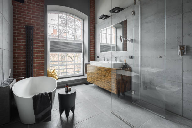 Industrial style bathroom Industrial style bathroom with oval bathtub and walk in shower industrial style photos stock pictures, royalty-free photos & images