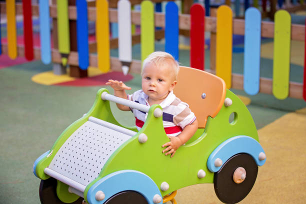 istock Little baby boy, playing on playground on sunset 1134249656
