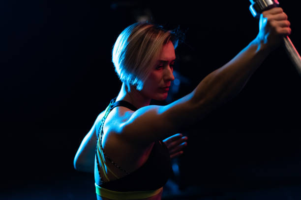 istock Young woman doing chin-ups on crosstraining training 1134250719