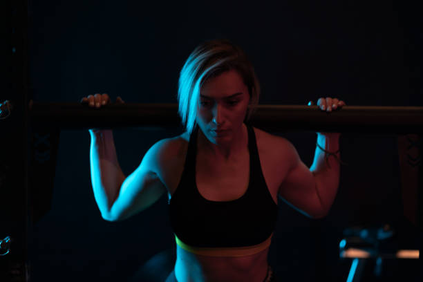 istock Young woman doing chin-ups on crosstraining training 1134250731