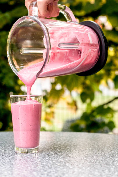 istock Making smoothie with banana and frozen berries 1134251360