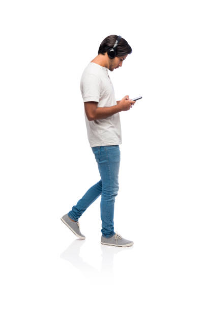 istock Young man walking while listening to music 1134251555