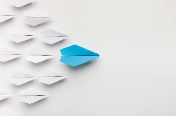 istock One blue paper plane leading group of white ones 1134251702